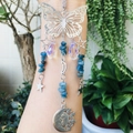 Detail of silver suncatcher with butterfly, moon pendants and blue raw stone crystal beads - Apatite