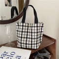 Detail of black and white tweed tote bag with golden button and canvas handles - Black Small Plaid Woolen