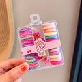 Close-up of colorful elastic hair bands and mini clips in a transparent storage box - Style 2