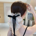 Large elegant floral print bow hair claw clip with black ribbons shown on model back view - White Floral