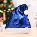 Close-up of a festive blue sequin Christmas hat with a soft white plush brim and pom-pom - Blue Flipping Gold