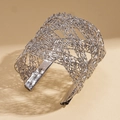 Detalle de brazalete abierto plateado con textura de malla metálica tejida intrincada - Bangle / Plateado
