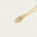 Gold Hamsa Hand necklace with white pavé zircons and a blue evil eye stone pendant - Evil Eye Hamsa Hand / 14K Gold Color