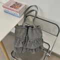 Detail of black and white plaid canvas tote with layered ruffles and drawstring closure - Black
