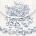 Macro shot of iridescent moon and star shaped beads for DIY jewelry making and crafts - Light Blue Grey