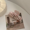 Macro detail of large pink and white marble acetate hair claw clip on aesthetic background - Dragon Bone Claw / Sakura Pink