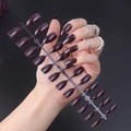 Close-up of glossy burgundy stiletto fake nails set on transparent rack with model hand - Glossy Burgundy (JJL-28)