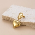Chic golden heart pendant earrings in C-shaped minimalist style on textured stone - Gold Hammered Heart Pendant Drop Earrings