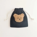 Close-up of black corduroy drawstring pouch with a brown plush bear patch and soft texture - Black (Coffee Bear)
