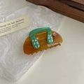 Detail of amber plastic shark clip with green handles and white numeric pattern printing - Green Number Print Handle Claw