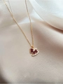 Elegant 18K gold plated necklace featuring a red zircon pony pendant on beige fabric - Rocking Horse Necklace / 18K Gold Plated / Gold Red