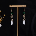 Detailed close-up of golden butterfly fringe earrings with white teardrop pearls and green beads - E3586 (Gold Retro Ruyi Green Bead)