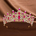 Golden bridal crown with pink and clear rhinestones on a brown textured background - Gold Rose Red