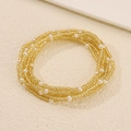 Yellow seed bead stretch bracelet set with white faux pearls on beige background - Gold Seed Beads and Pearl Multi-strand Bracelet (14 金色3745)