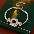 Detail of flower bracelet featuring dark blue oval stone and pear-shaped zircons - Silver Blue Flower Style