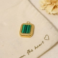 Close-up of a gold-plated rectangular green stone pendant on a cream fabric pouch - Pendant Only (Without Chain)-Rectangular Green Stripe (SAC23061901)