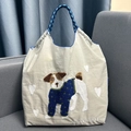 Detailed close-up of cute dog embroidery and braided handles on beige nylon tote bag - L / Light Gray Pug