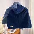 Blue gradient knitted turtleneck scarf wrap on a wooden hanger in a cozy home setting - Blue
