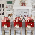Three Christmas chair covers with Santa motifs and Merry Christmas text in a kitchen - Single Chair Cover / Santa Claus