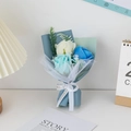 Close-up of handmade soap flower bouquet with white and blue roses in premium gift wrap - Blue