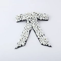 Macro detail of luxury black bow hair clip with white pearls and sparkling rhinestone inlay - Black Velvet with White Pearls