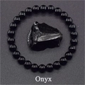 Macro detail of natural black onyx beads bracelet with raw stone texture and text - Onyx