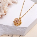 Golden titanium necklace featuring a rotating four-leaf clover pendant with pink gemstones - Rotating Pink