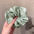 Glossy sage green pleated silk scrunchie with soft satin texture and layered design - Green