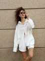 Women's white linen long sleeve shirt and shorts casual set standing by stone wall - White