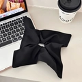 Elegant black plaid bow hair scrunchie shown in a stylish minimalist lifestyle setting - Black Plain Scarf