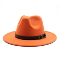 Close-up of bright orange wool fedora hat featuring a leather band and gold buckle - Orange