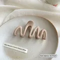 Large apricot matte wavy shark hair claw clip for women on a ceramic tray, 10.5x5cm - Khaki
