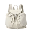 Close-up of nylon backpack with drawstring closure, zipper pocket and silver buckle detail - Bone White