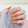 Detailed view of long ballerina-style fake nails in glossy bright orange on hands - Jelly Glue Type / Bright Orange (CBLL-05)