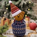 Festive blue knitted Christmas gift bag featuring a cute teddy bear with a striped hat - Bear