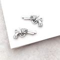 Macro shot of two vintage silver revolver alloy charms for DIY jewelry making - Revolver Gun Charm (1pc)
