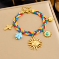 Detail of colorful woven bracelet with gold charms including sun mask and turquoise - Sun Face and Cross Style (B1794)