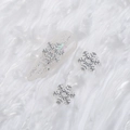 Silver alloy snowflake nail art charms with crystal rhinestones on a glitter tip - Style A1143-05