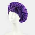 Detail of a purple satin bonnet showing silk-like texture and a large decorative bow - One Size / Deep purple