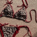 Two-piece leopard print bikini set with contrasting red ties on woven background - XS / Red Leopard