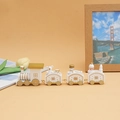 Detail of white and gold wooden Christmas train with miniature bear and snowman figures - White
