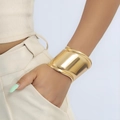 Minimalist wide C-shape open bangle in shiny gold finish worn by model on white background - Gold Wide Mirror Polish Bracelet (D1527)