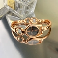 Detail of rose gold chain strap and roman numeral dial on a vintage women's watch - Rose Gold Case Black Dial