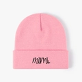 Detail of pink knitted beanie featuring black cursive mimi embroidery on the folded cuff - Pink
