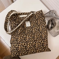 Macro shot of leopard print canvas tote bag with a minimalist white fabric label - Brown and Yellow Leopard Print