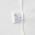 Detail of size S garment label showing 50% viscose fabric composition on white knitwear - 50% Viscose 30% Polyester 20% Nylon (White)