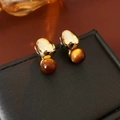 Detail of vintage gold-tone earrings with tiger eye beads on black jewelry box - Gold (Silver Earring Post)