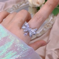 Macro detail of silver bow ring with zircon pavé and teardrop crystal on silk fabric - Bowknot Waterdrop Drip Style (312) / Adjustable Open