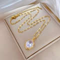 Close-up of gold necklace with oval white gemstone pendant on a luxury jewelry box - Gold Titanium Steel Chain Copper Zirconia Pendant