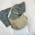 Minimalist beige nylon crescent crossbody bag with woven zipper and adjustable strap - White